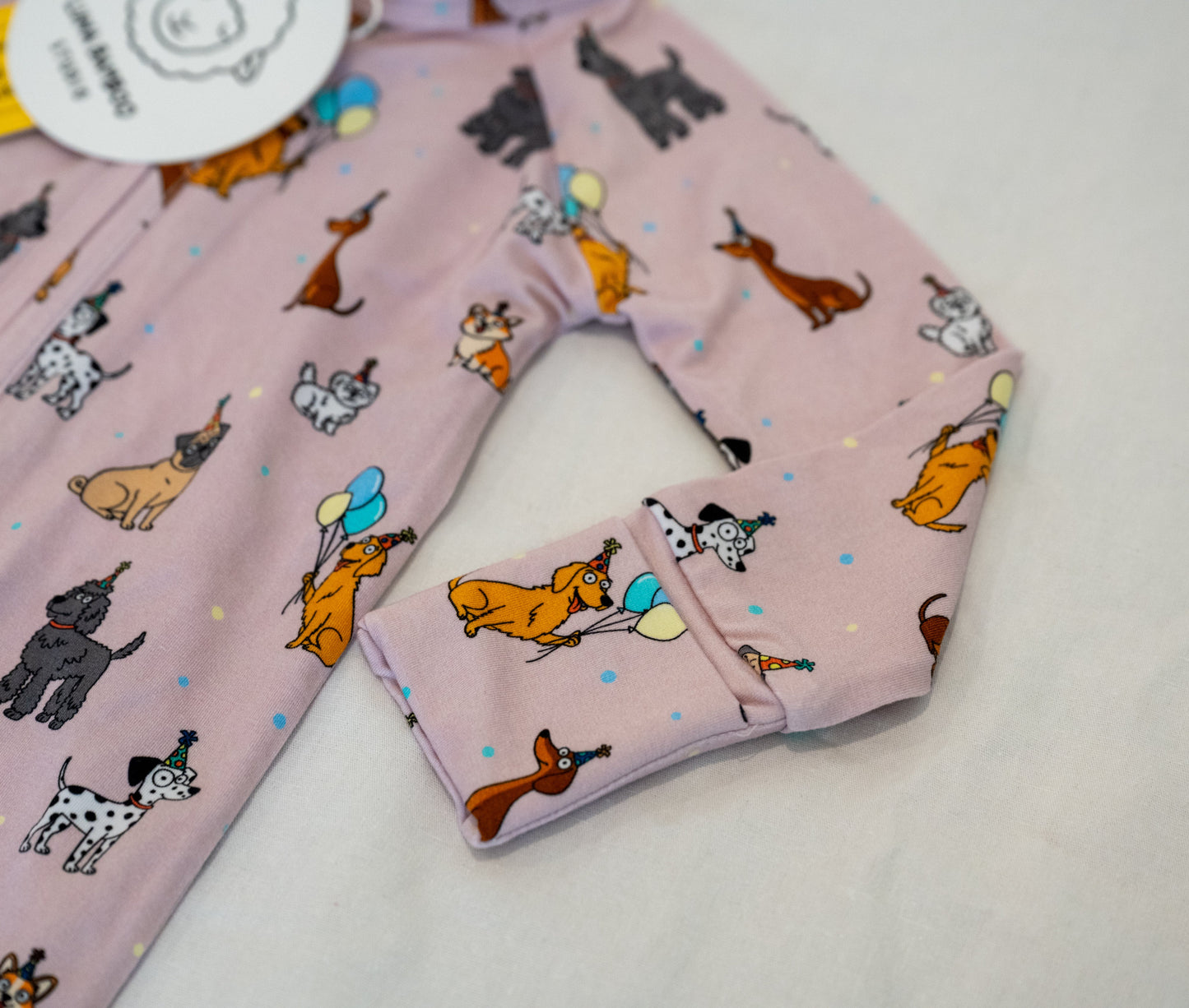 Close up for cuff Pink bamboo zip sleeper with puppy print for babies