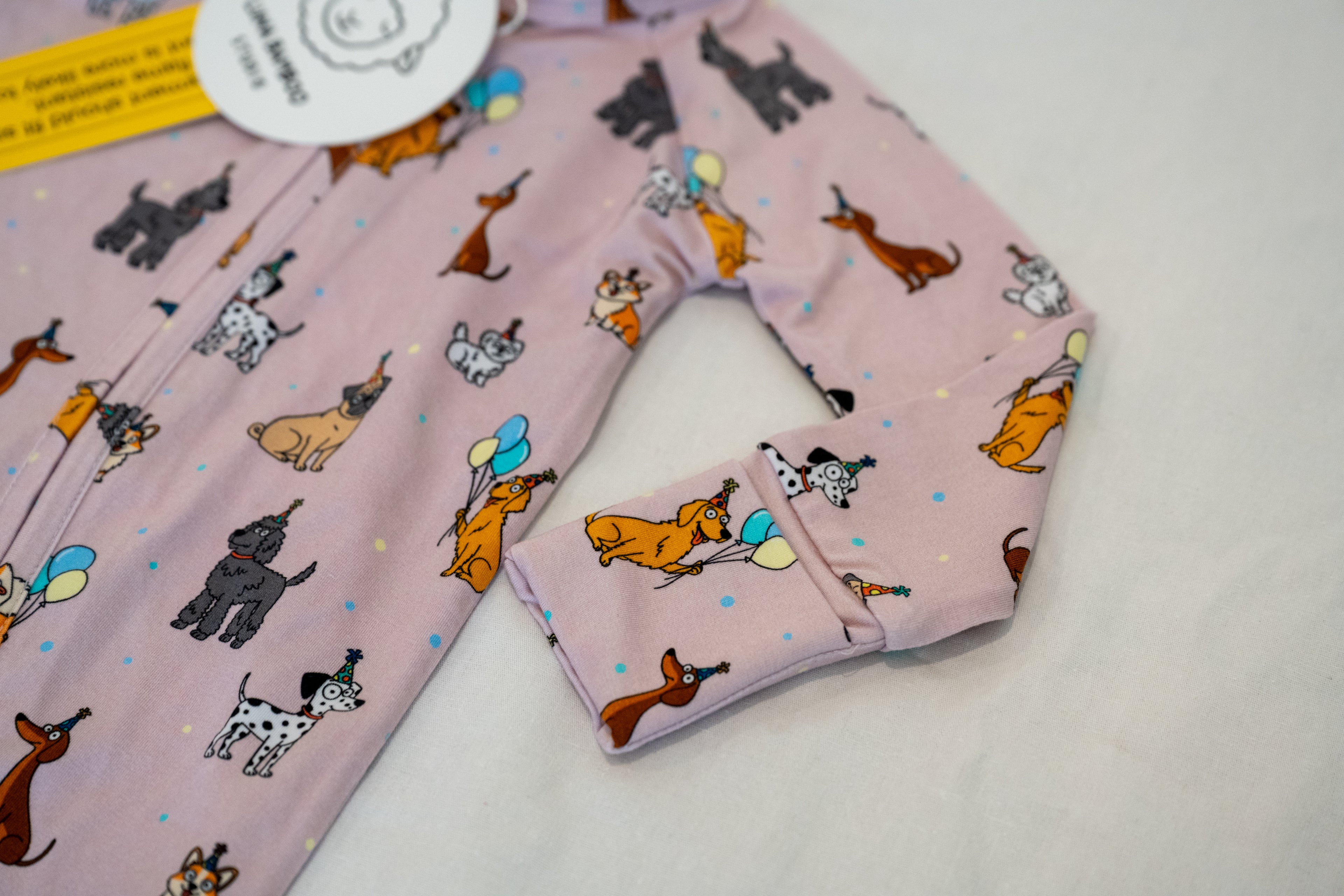 Close up for cuff Pink bamboo zip sleeper with puppy print for babies
